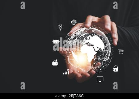 A businessman's hand holds a globe, illustrating seamless connectivity and data flow across global network Stock Photo