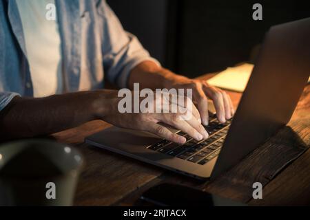 Freelancer typing on laptop in home office Stock Photo
