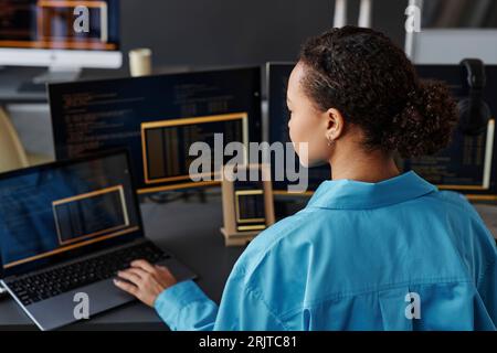 Young computer programmer working on laptop in office Stock Photo
