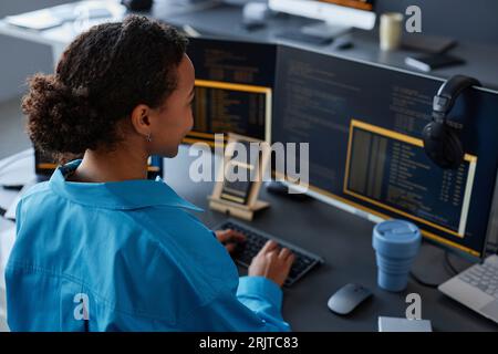 Computer programmer working on desktop PC in office Stock Photo