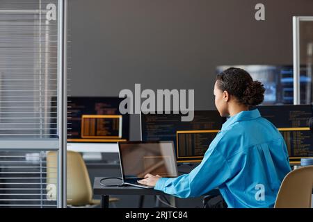 Computer programmer working on laptop in office Stock Photo