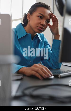 Stressed computer programmer working on desktop PC Stock Photo