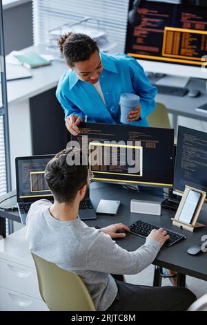 IT professional discussing over desktop PC with colleague Stock Photo