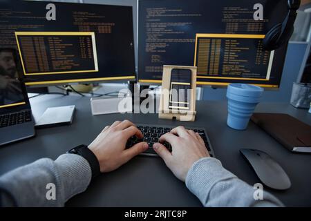 Hands of IT professional typing on keyboard at desk Stock Photo
