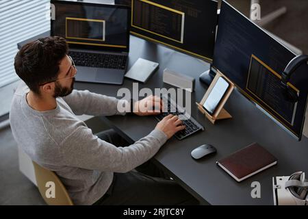 IT professional working on computer at desk in office Stock Photo