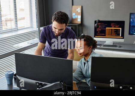 IT professionals discussing over computer in office Stock Photo
