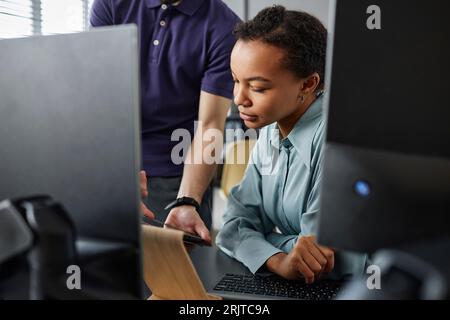 IT professional having discussion with colleague over tablet PC in office Stock Photo