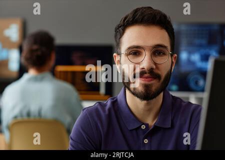 Smiling IT professional wearing eyeglasses Stock Photo