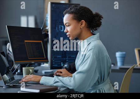 Young computer programmer working on laptop in office Stock Photo