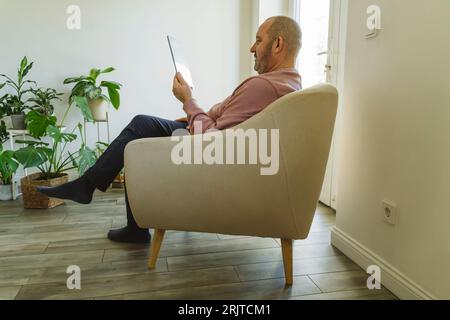 Senior man using tablet PC at home Stock Photo