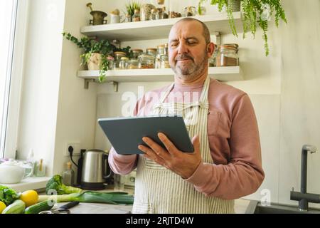 Senior man using tablet PC at home Stock Photo