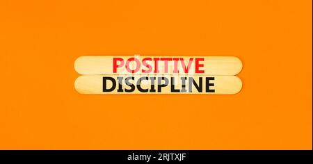Positive discipline symbol. Concept words Positive discipline on beautiful wooden stick. Beautiful orange table orange background. Business psychology Stock Photo