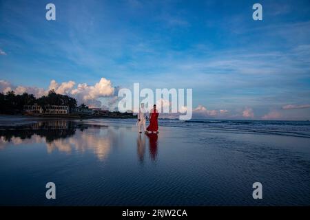 A couple walking on the sea beach at Saint Martin's Island, locally known as Narkel Jinjira, is the only coral island and one of the most famous touri Stock Photo