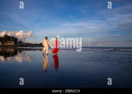 A couple walking on the sea beach at Saint Martin's Island, locally known as Narkel Jinjira, is the only coral island and one of the most famous touri Stock Photo