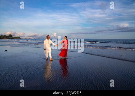 A couple walking on the sea beach at Saint Martin's Island, locally known as Narkel Jinjira, is the only coral island and one of the most famous touri Stock Photo