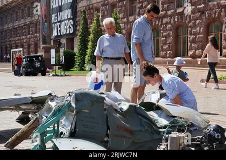 People look at a destroyed Russian missile displayed as a symbol of war in the center of Kyiv. Stock Photo