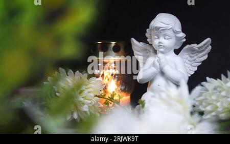Condolence card with funeral candle, angel and flower Stock Photo
