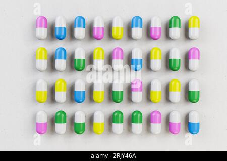 Pharmacy concept: differently colored pills / capsules arranged as flat lay on a sheet of paper. Stock Photo