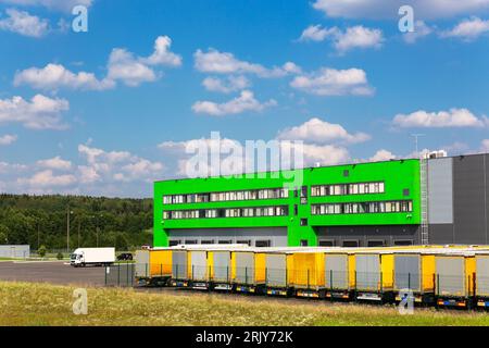 Distribution warehouse with trucks of different capacity. Transportation service delivery station. Big distribution warehouse with gates for loads and Stock Photo