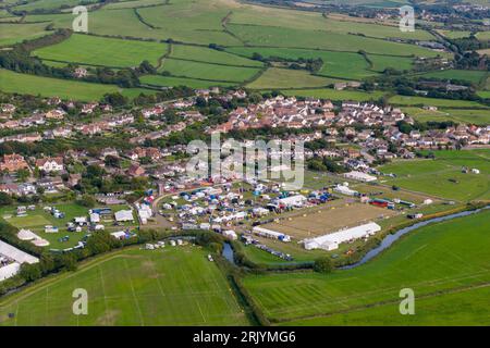 West Bay, Dorset, UK.  23rd August 2023.  UK Weather.  General view from the air of the Melplash Show ground at seaside resort of West Bay on the Dorset Jurassic Coast on an afternoon of scorching hot summer sunshine.  Picture Credit: Graham Hunt/Alamy Live News Stock Photo