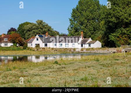 A National School building 1834 with commemorative plaque, Bosham, a coastal village on the south coast near Chichester, West Sussex, southern England Stock Photo