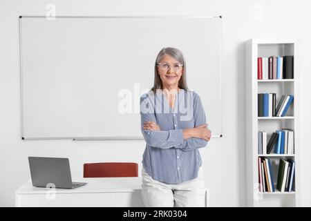 Portrait of professor near whiteboard in classroom Stock Photo