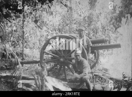 Invasion of the Philippines, December 1941 – May 1942. Imperial Japanese Army troops pose with a captured US M1917 75mm field gun after taking an American artillery position on Mount Samat during the Battle of Bataan, April 5 1942. Stock Photo