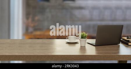 Close up office desk with Computer laptop copy space on table in modern co-working space workplace at business district background interior cafe Stock Photo