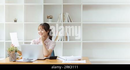 employee with paper work inside office, female financier worker thinks about contracts and reports with charts and graphs, successful woman uses Stock Photo
