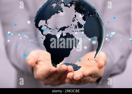 A person displaying a digital globe. the concept of communication Stock Photo