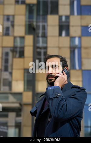 Muslim businessman talking on mobile phone. Arab businessman talking on mobile phone Stock Photo
