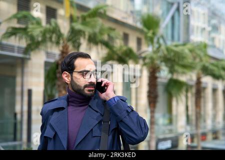 Muslim businessman talking on mobile phone. Arab businessman talking on mobile phone Stock Photo
