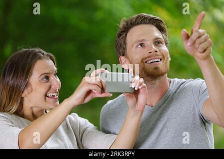 young female hiker and boyfriends pointing at something out Stock Photo