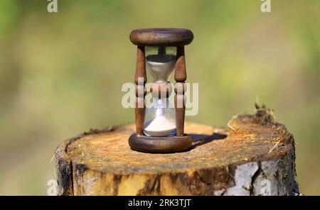 Abstract hourgflass on wooden stump Stock Photo