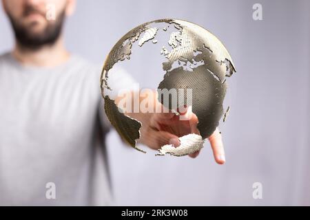 A person displaying a digital globe. the concept of communication Stock Photo