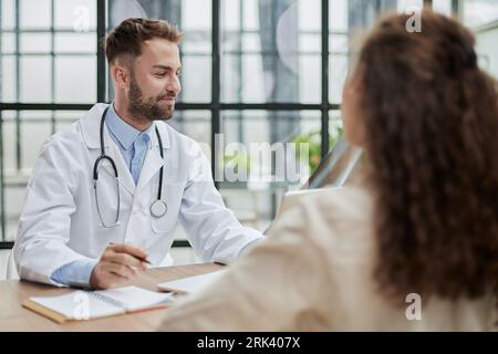 Concentrated male doctor looking at x-ray picture of spine Stock Photo