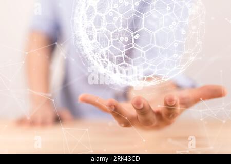 A man holding a sphere with interconnected polygons. concept of a global digital telecommunications Stock Photo