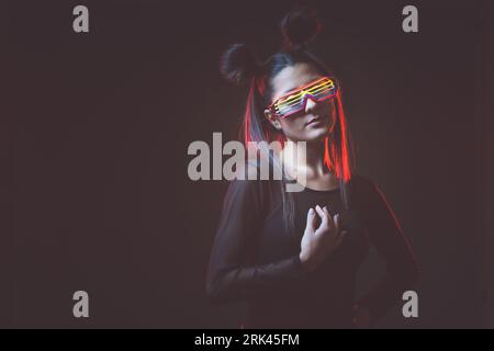 Portrait Of Serious Cyber Woman In Wire Led Glasses Standing In Light Of  Neon Sign Stock Photo - Download Image Now - iStock