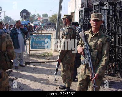 A police officer and club security personnel detain a man in