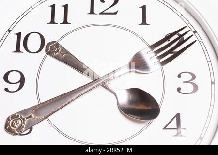 Clock made of spoon and fork Stock Photo