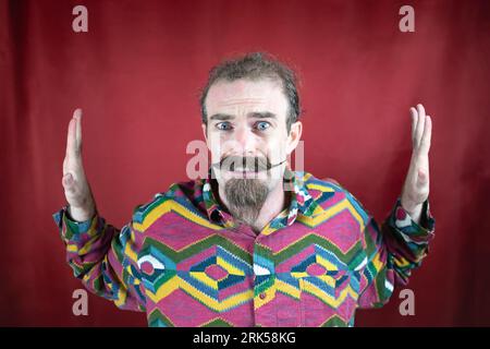 Hipster terrified man with mustache and hands blocking sides with fear face Stock Photo