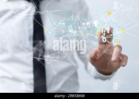 A Cbusinessman interacting with the digital interface of a computer Stock Photo