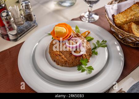 Gourmet tartar raw from beef fillet with onion rings Stock Photo