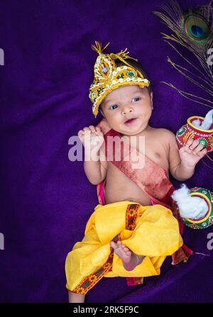 newborn baby boy in krishna dressed with props from unique perspective in different expression Stock Photo Alamy