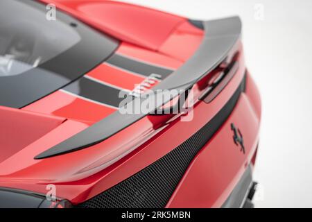 A vibrant red Ferrari 488 sports car against a white background Stock Photo