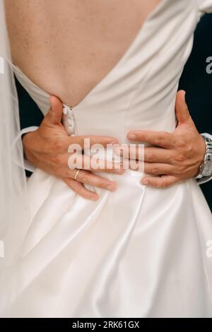 A man and woman in formal attire stand side by side Stock Photo