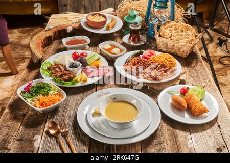 Classic Turkish-style breakfast from above. Delicious rich Traditional Turkish breakfast including tomatoes, cucumbers, cheese, butter, eggs, honey. Stock Photo