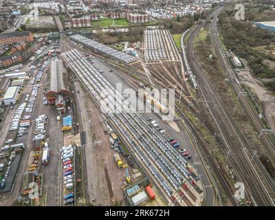 An aerial view of a bustling train yard with several trains idling in the area Stock Photo