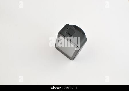 Explore the world through the lens of this black 4K action camera, strategically placed on the table. Stock Photo
