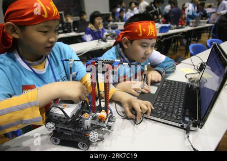 Bildnummer: 53896542  Datum: 27.03.2010  Copyright: imago/Xinhua (100328) -- JINAN, March 28, 2010 (Xinhua) -- Two little contestants from the Beijing Delegation input the computer programme for the operation of their robot, during the China Open Match of the 2010 FLL Robot World Cup, which carries the theme of Intelligent Transport and draws over 1,000 contestants in 80 teams from 18 provinces and cities on mainland China and Hong Kong to take part in, at Jinan, east China s Shandong Province, March 27, 2010. (Xinhua/Lv Chuanquan) (px) (1)CHINA-JINAN-FLL 2010 ROBOT WORLD CHAMPIONSHIP-CHINA OP Stock Photo